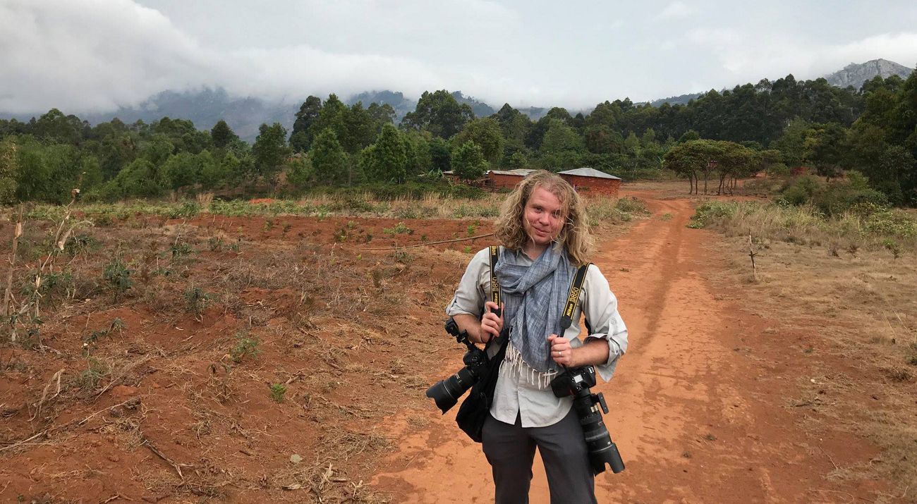 Alex Snyder with his photography gear in Tanzania.