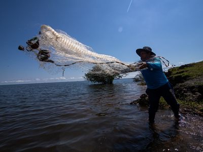 Pescador lanzando su red sobre el rio Tapajos.