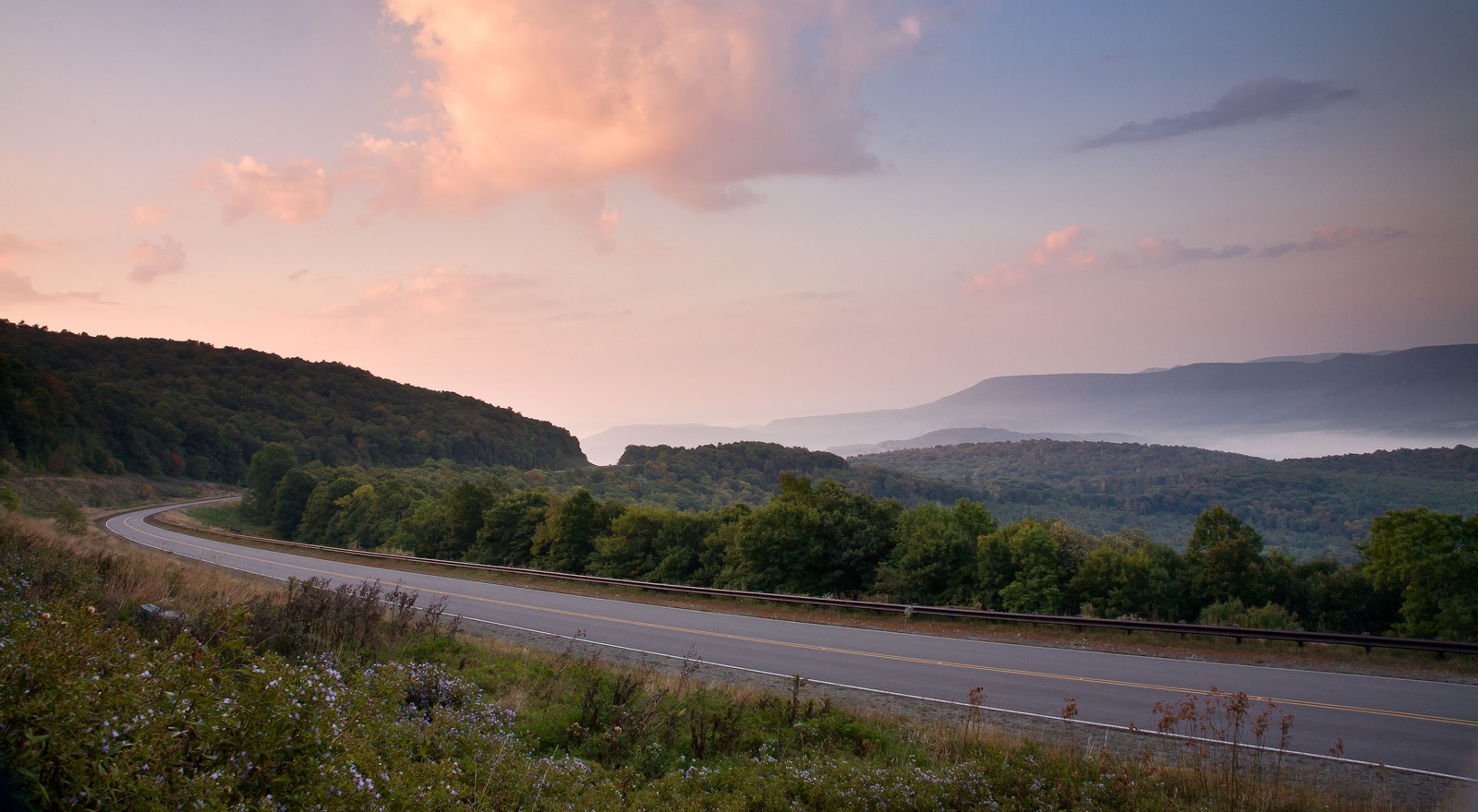 Photo of a highway running through the Appalachian Mountains of West Virginia at sunset.