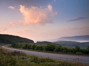 Photo of a highway running through the Appalachian Mountains of West Virginia at sunset.