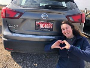 Woman pictured with specialty bison license plate.