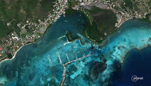Aerial photo looking down at land and blue waters of Ashton Bay on Union Island in the Grenadines.