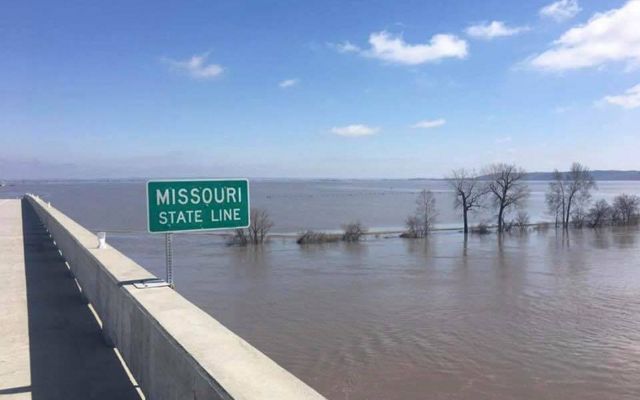 A Missouri State sign along the highway surrounded by flood water.