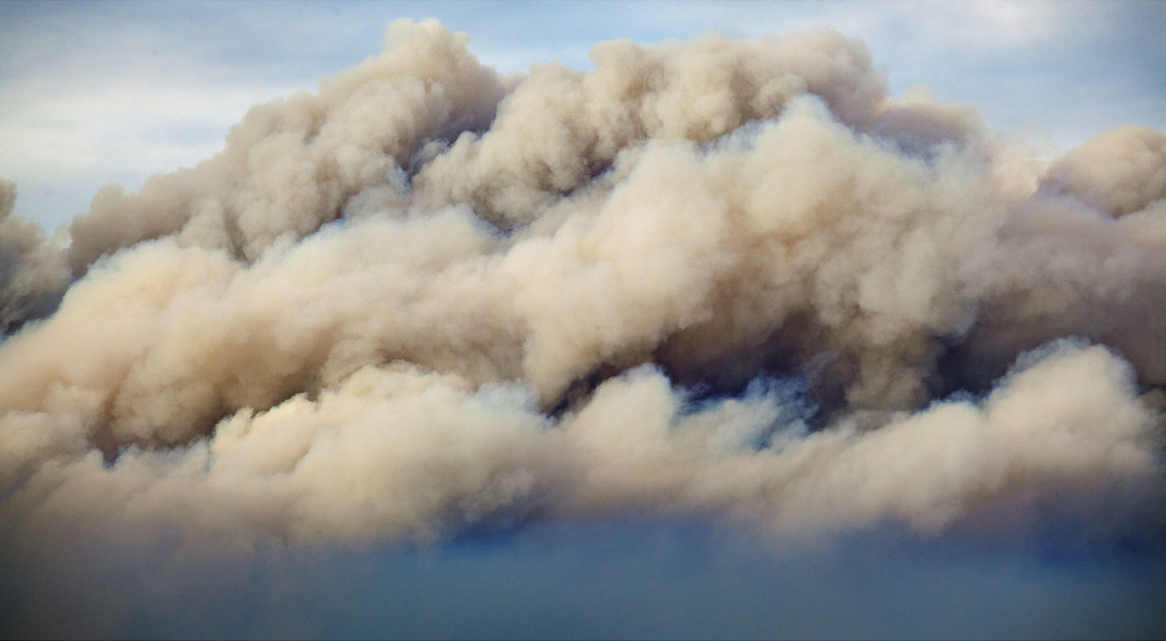 Smoke rises up during a devastating fire season in Australia. Climate change is contributing to these record fires. 