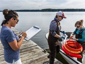 The Nature Conservancy's Alix Laferriere (left) records information with SOAR program participants Krystin Ward of Choice Oysters and Laura Brown (right) of Fox Point Oysters on the University of New Hampshire's JEL Lab dock on Great Bay in Durham, New Hampshire.