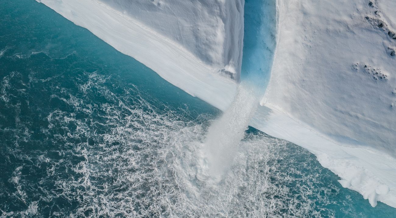 A aerial view of a water canal in an ice shelf.