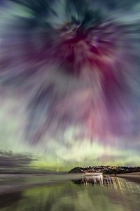 The sky in shades of bright pink and green.