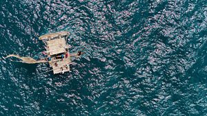 Overhead image of a traditional islander canoe in the ocean.