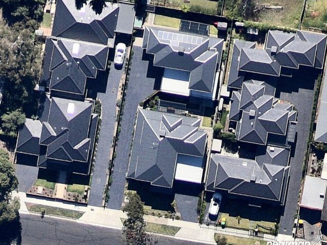An aerial view of 8 houses and no tree canopy cover