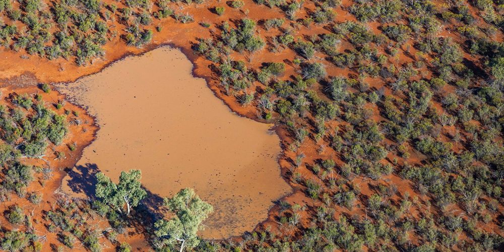 An aerial view of Cuttaburra Park showing unique ochre colour ground.