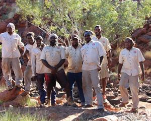 a group of people poses for an outdoor photo