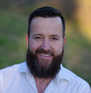 Smiling man with a brown beard