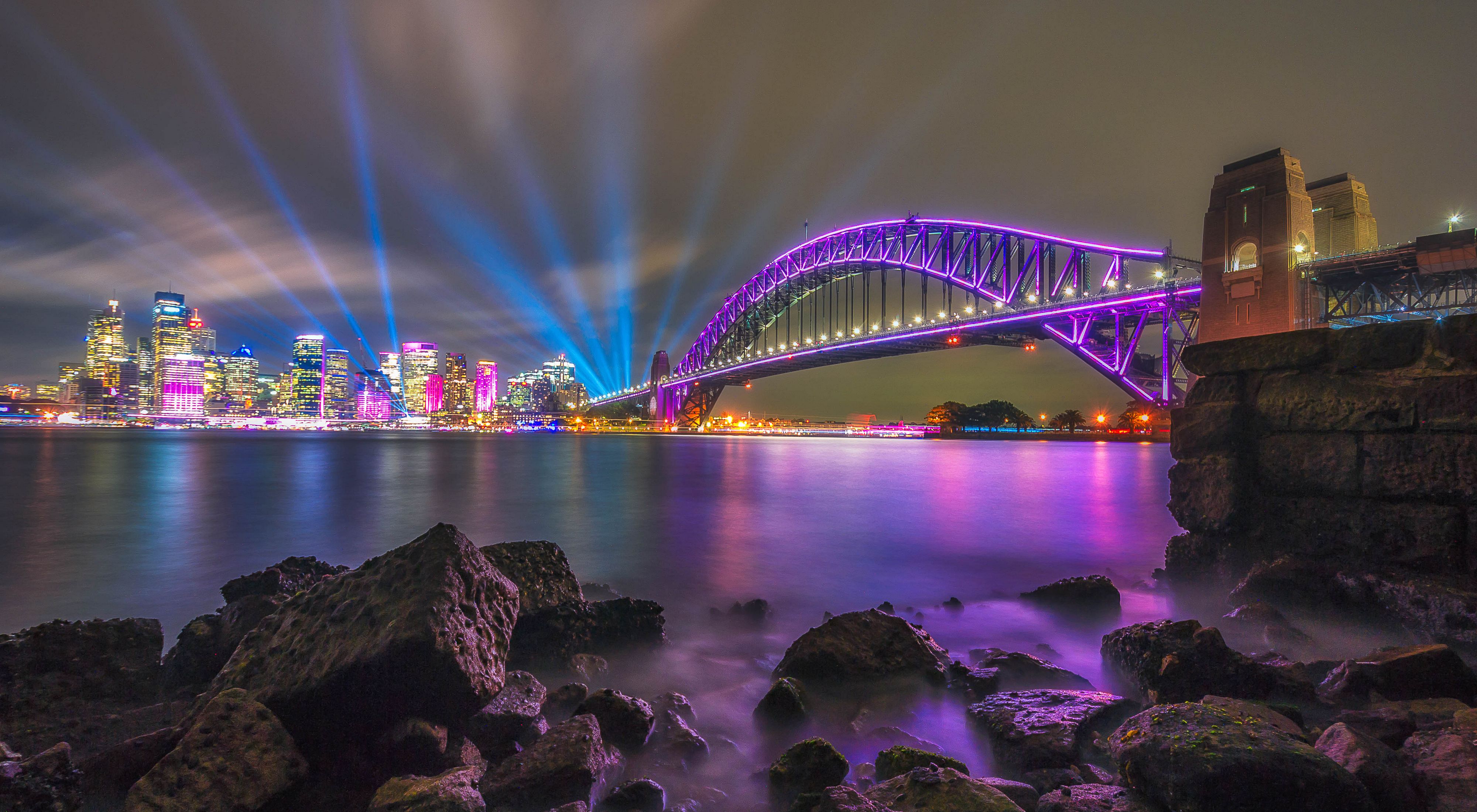 a city bridge lit up in purple