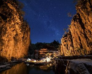 Camping under the stars in a remote sandstone gorge in the Northern Territory