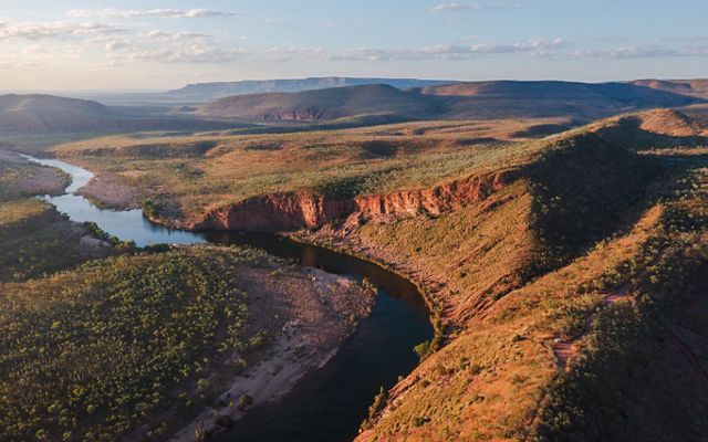 an aerial image of a river flowing through an arid valley.
