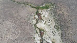 An aerial view of a hot spring in the desert.