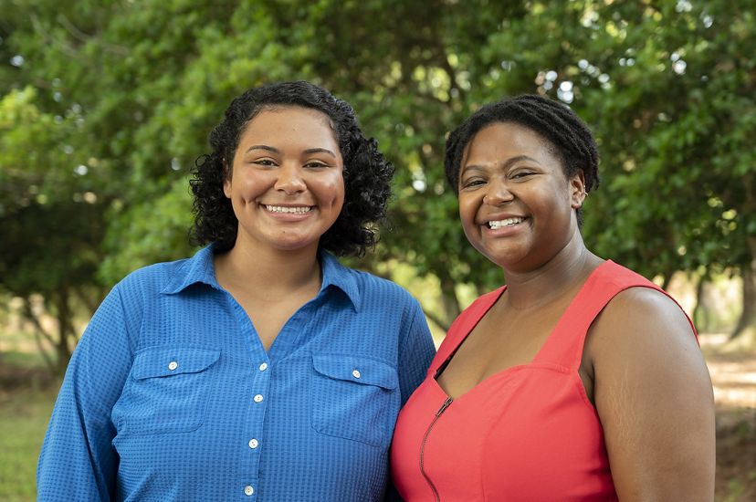 Interns Basia Scott and Vanessa Moses pose together on the grounds of Virginia's Brownsville Preserve during a marketing retreat.