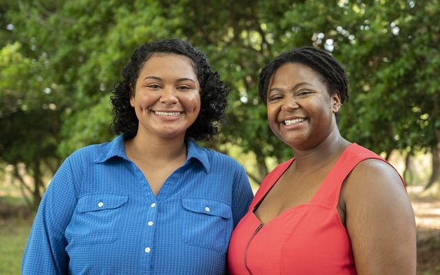 Interns Basia Scott and Vanessa Moses pose together on the grounds of Virginia's Brownsville Preserve during a marketing retreat.