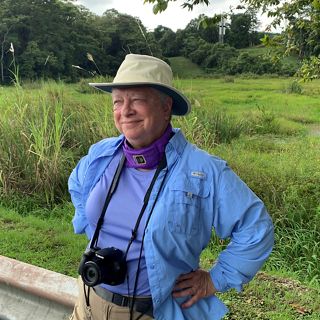 Headshot of Barbara Brummer as she poses in nature.