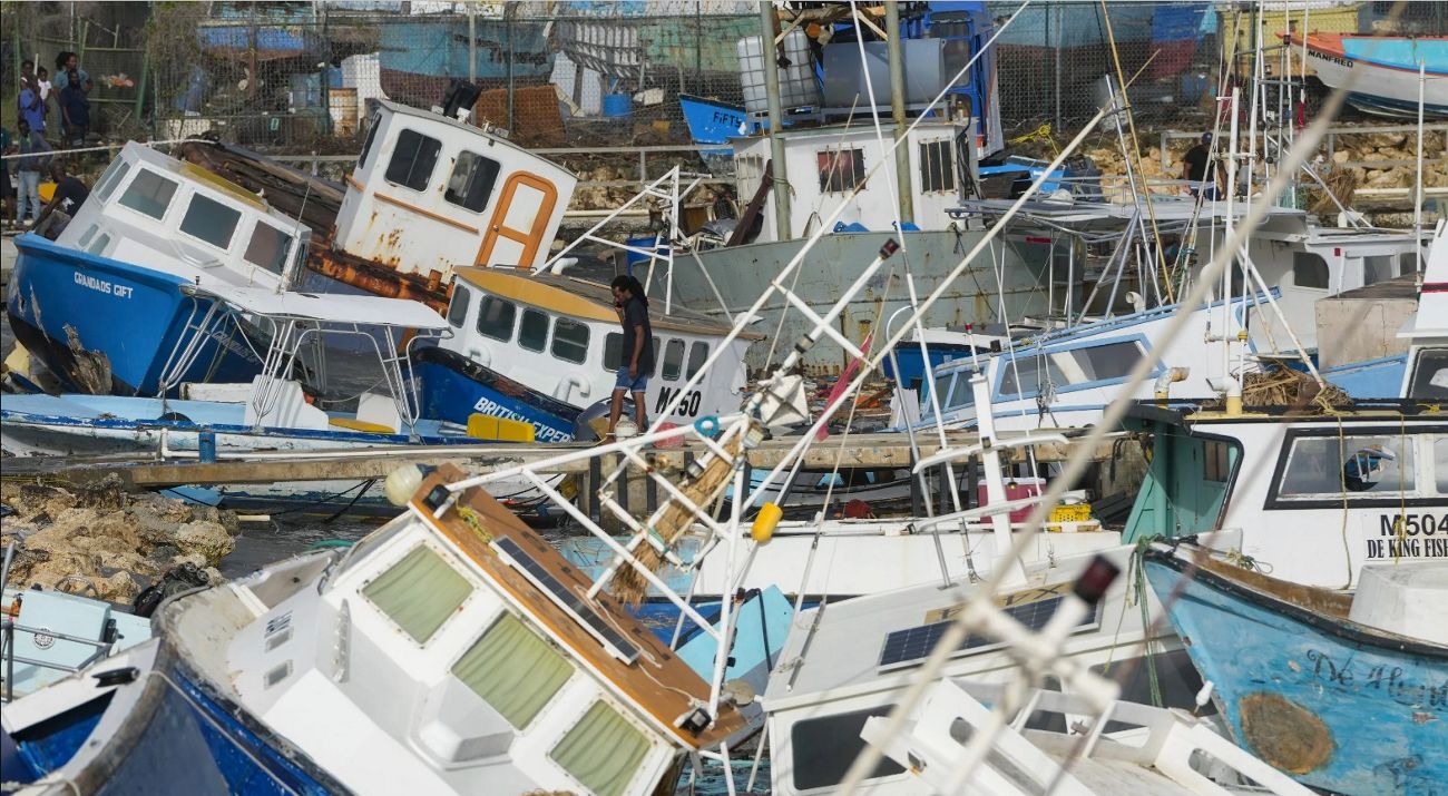 fishing boats laying on top of each other after a hurricane.