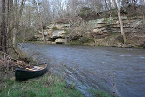 Kayak on bank of creek.