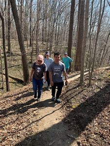 Small group of hikers walk the Tall Timbers Trail at Big Walnut.