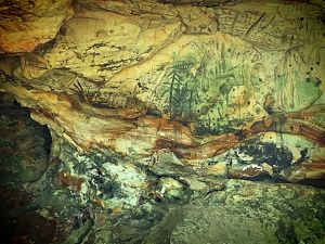 Writings on a cave wall are identified as created by Indigenous peoples.