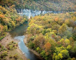 The Buffalo National River flows past rock bluffs.