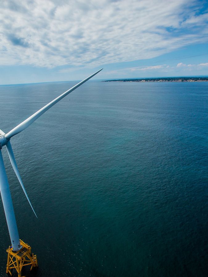 Wind turbine over a large body of water.