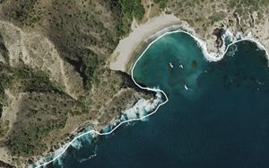 Aerial imagery of boats on the shores of Santa Cruz Island. The property boundary is displayed as a white line.
