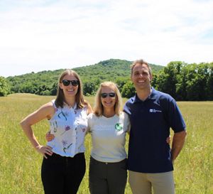 Three people smiling at the camera.