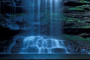 A small waterfall flows into a lake.