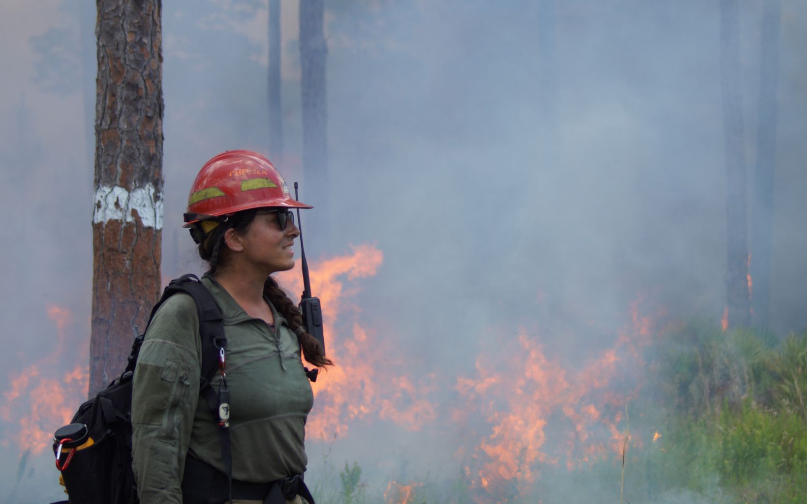 Fire for Habitat Restoration Central Florida land conservation specialist Chelsea MacKenzie monitors a prescribed burn on The Disney Wilderness Preserve.  © Hannah O'Malley/TNC