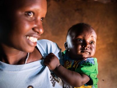 A woman holding a small baby