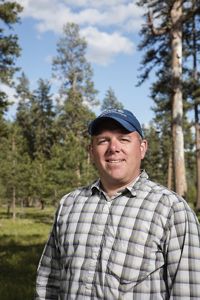 Headshot of Chris Bryant in forested landscape.
