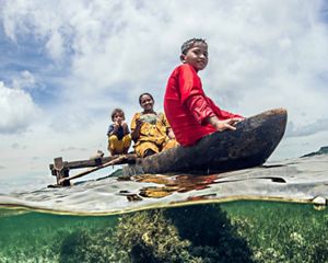 A family fishing in their canoe.