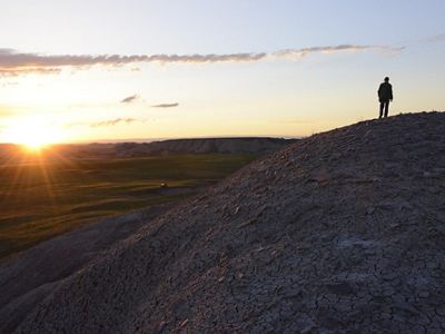 Sun sets over the hilly South Dakota landscape.
