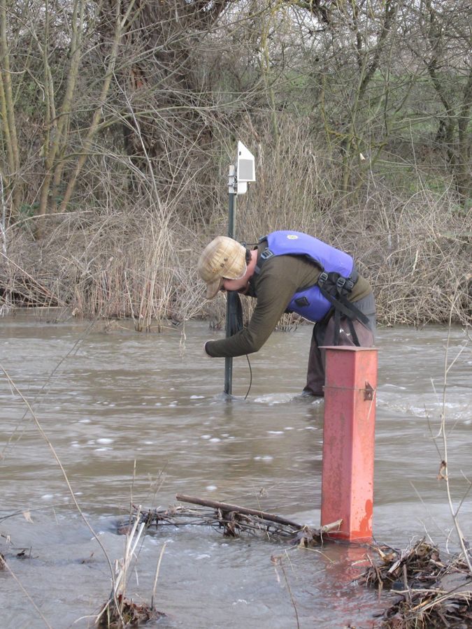 Scott Hardage checking an instrument to record water.