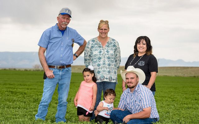 The Cotner family posing in their Utah farm field.