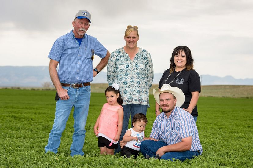 The Cotner family posing in their Utah farm field.