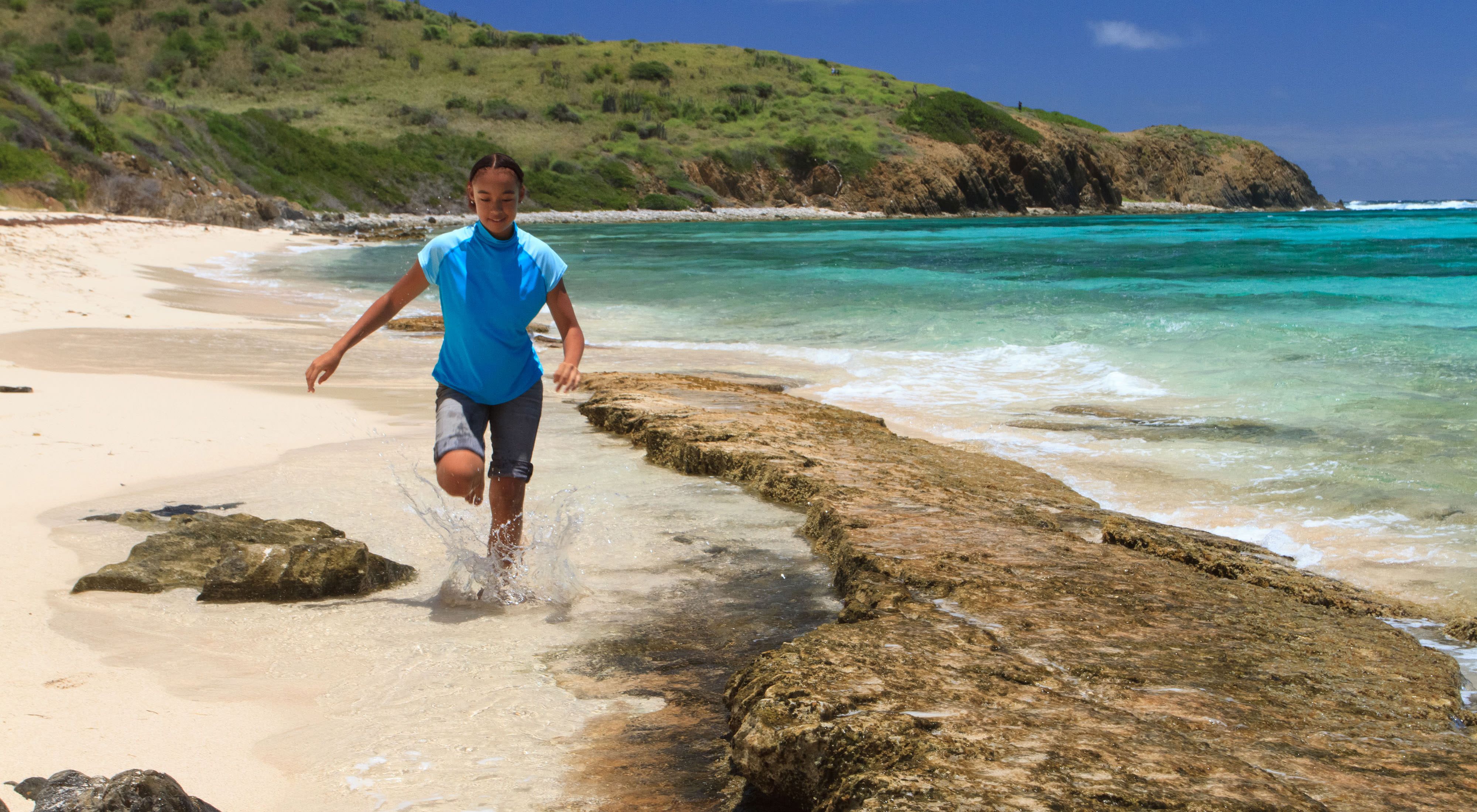 A girl runs along the beach at Jack and Isaac Bay Preserve in St. Croix, U.S. Virgin Islands.