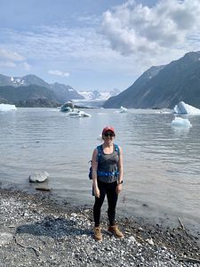 Dr. Hannah Birge standing in front of a glacier.