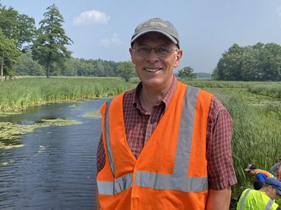 A candid headshot of Bill Brown in an orange vest.