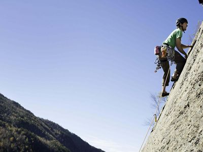 A man climbing the side of a mountain.