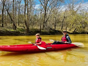 Craig and his son in a canoe