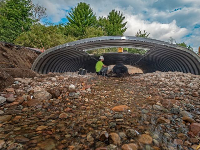 A person under a culvert.