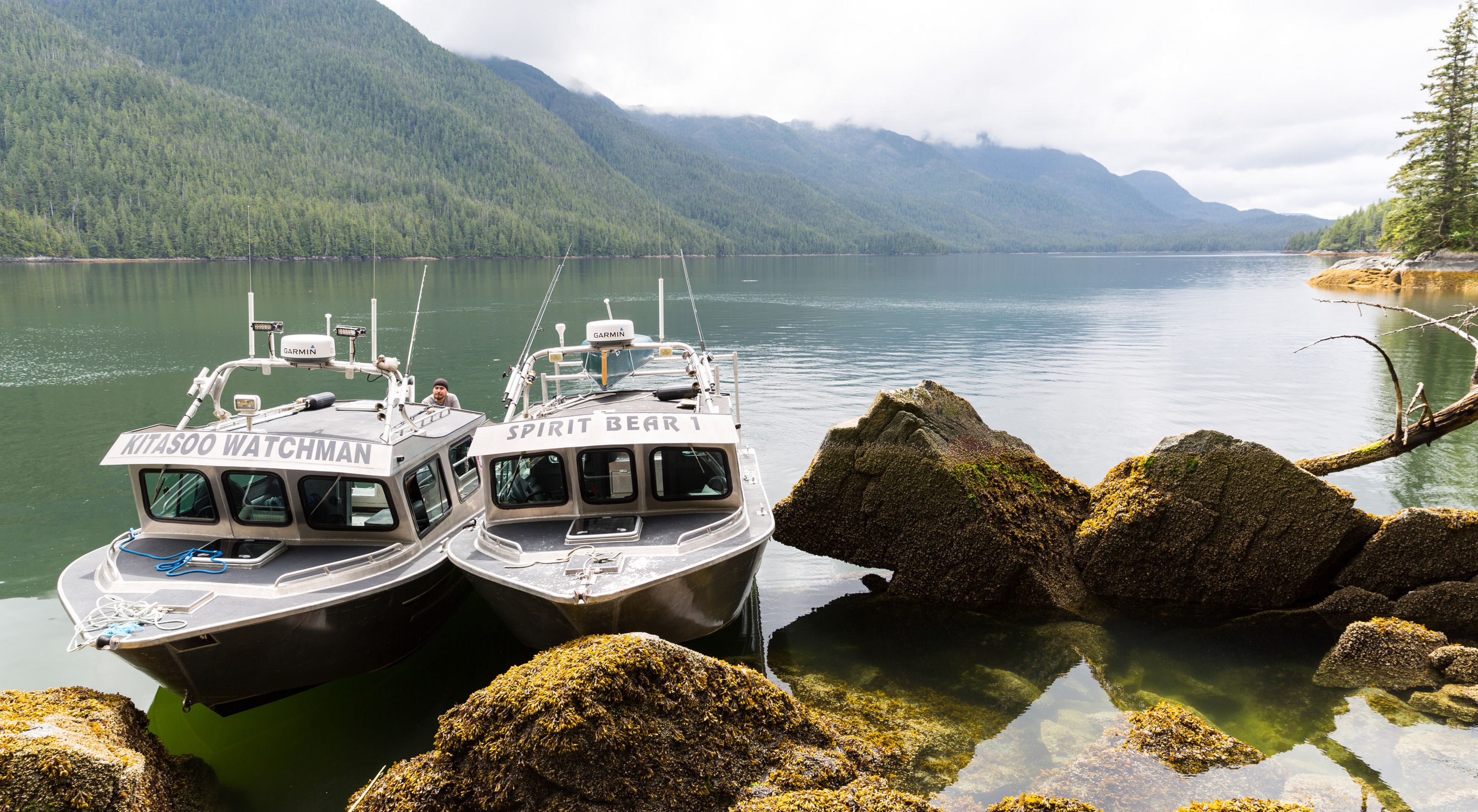 two Indigenous Guardians patrol boats tied up at the shoreline