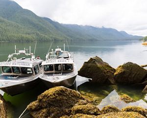 two boats parked near some boulders