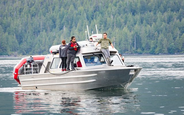 SEAS student Tina Lobbes on a boat with fishermen Justin and Vernon Brown in Great Bear.