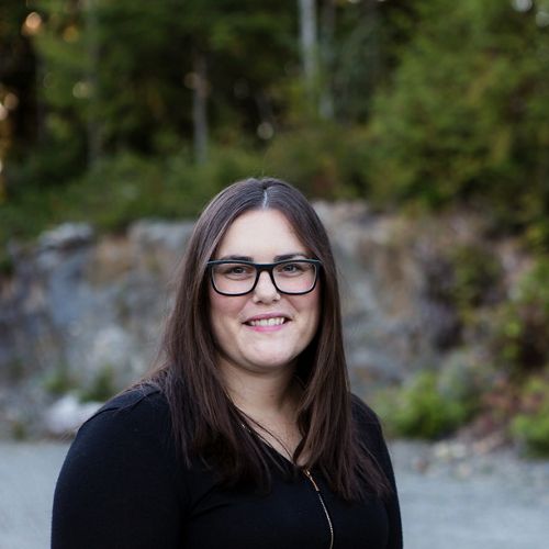 headshot of woman with dark hair and glasses